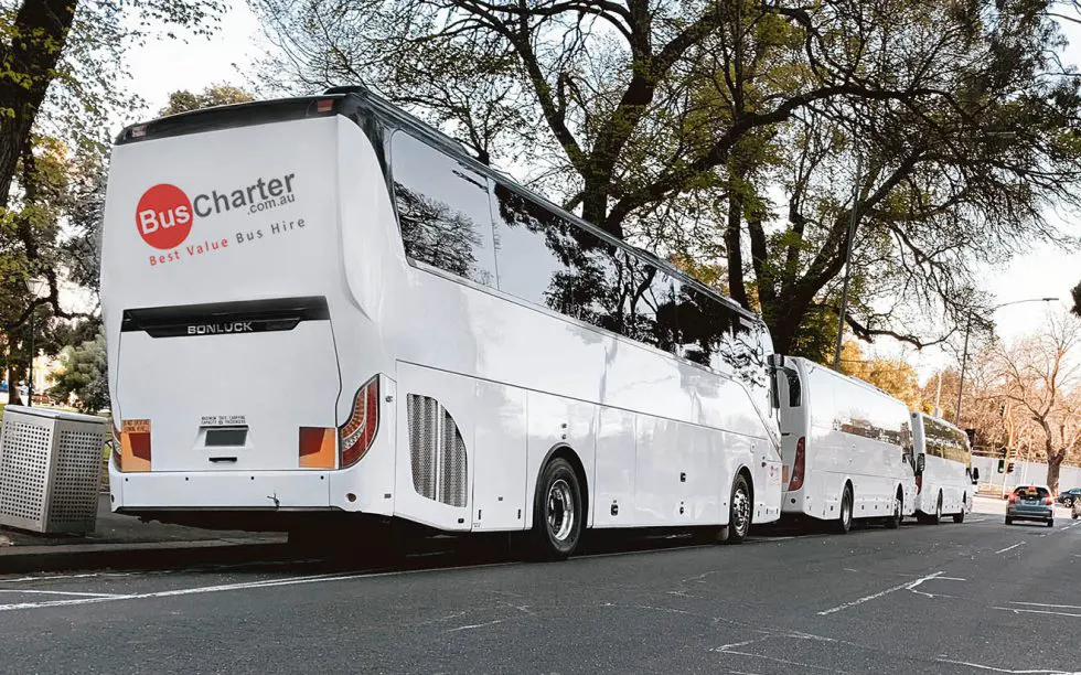 Bus charter coach parked on the side of the street ready to collect guests.