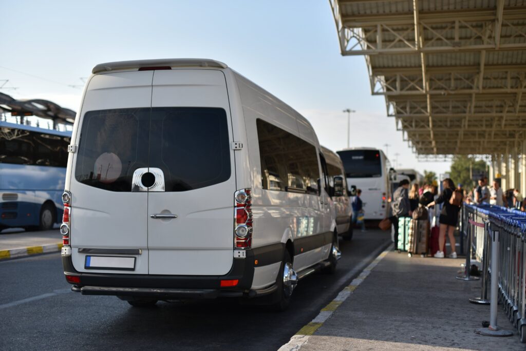 Mini bus charter waiting to collect and transport guests from airport.