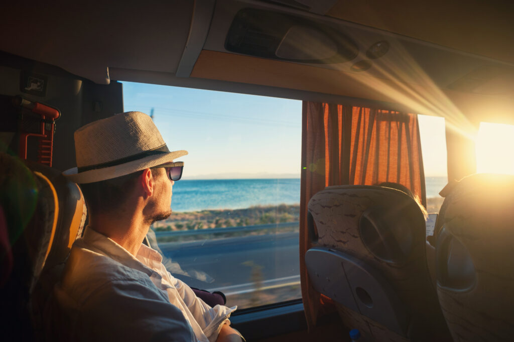Traveller on a city tour bus of Adelaide looking out the window.
