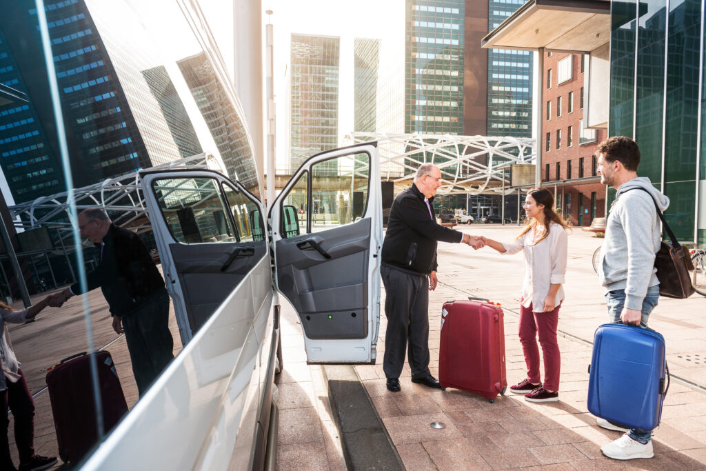 Friendly bus driver greeting guests at airport prior to their airport transfer.