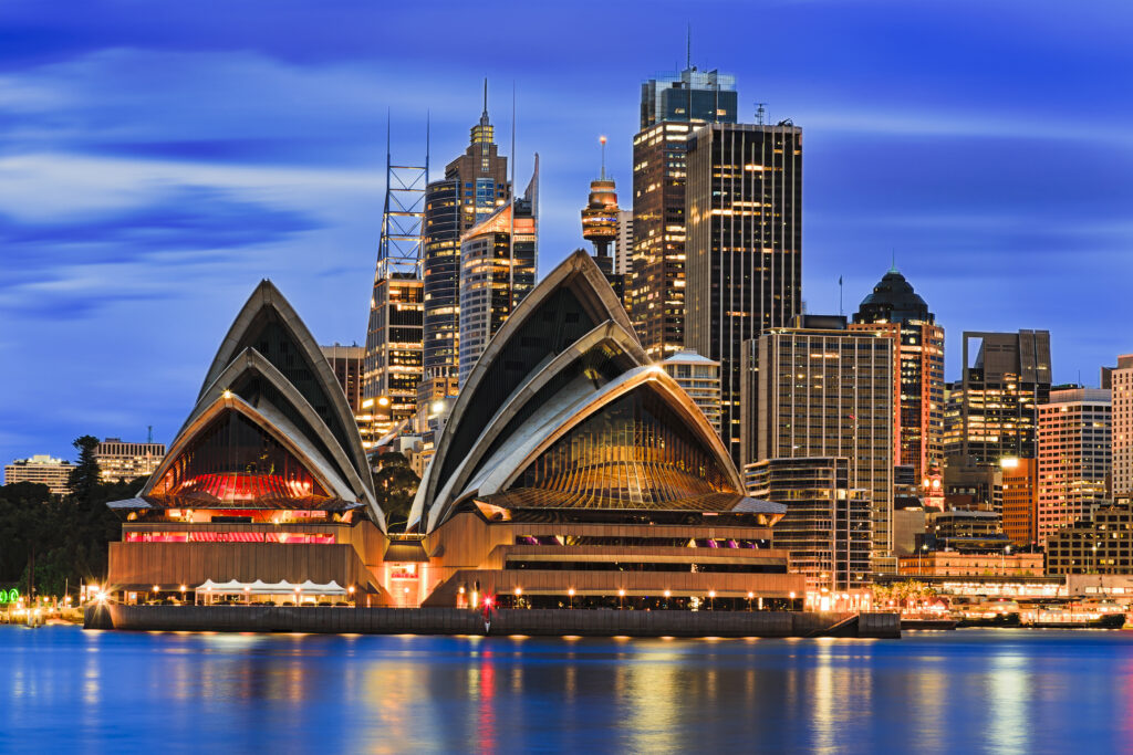 Sydney Opera House at dusk with Sydney CBD behind
