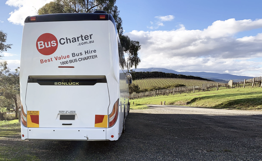 bus-charter-vehicle-stationed-at-vineyard-for-sightseeing-tour-group