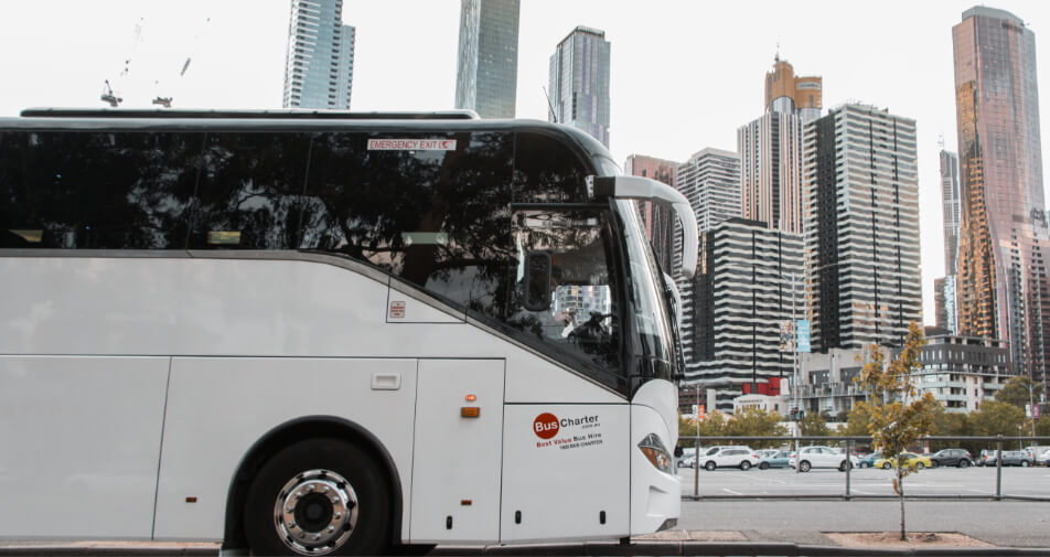 Bus charter coach in front of Melbourne city.