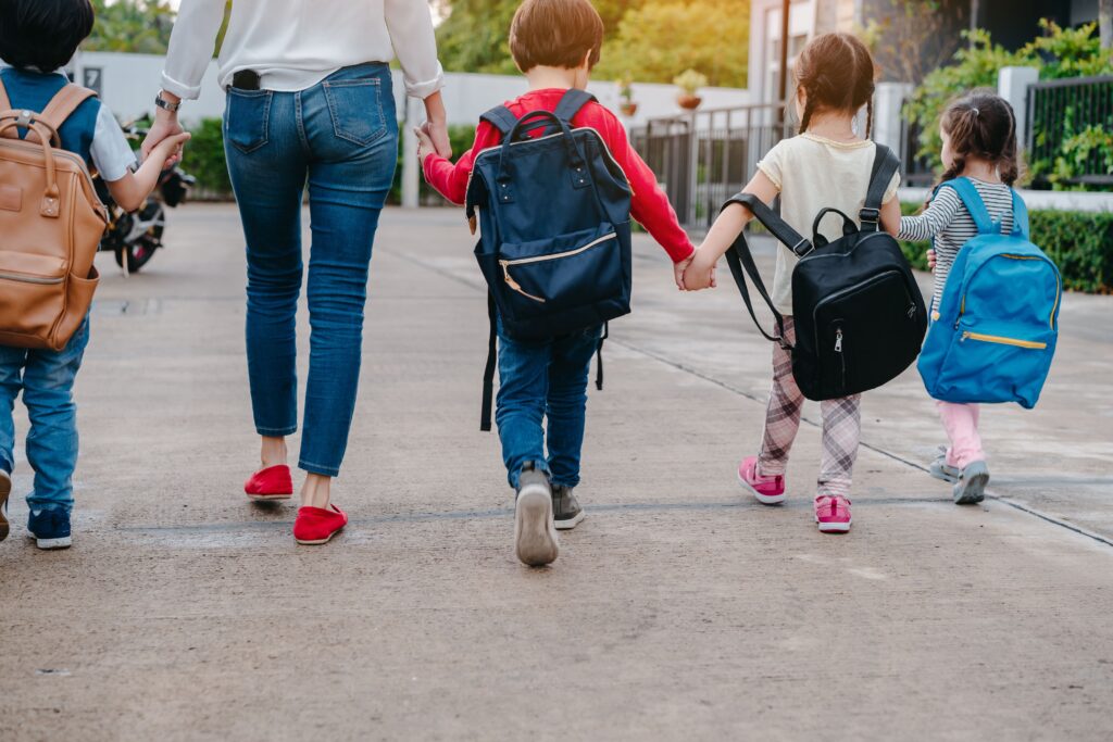 Mother walking kids to school